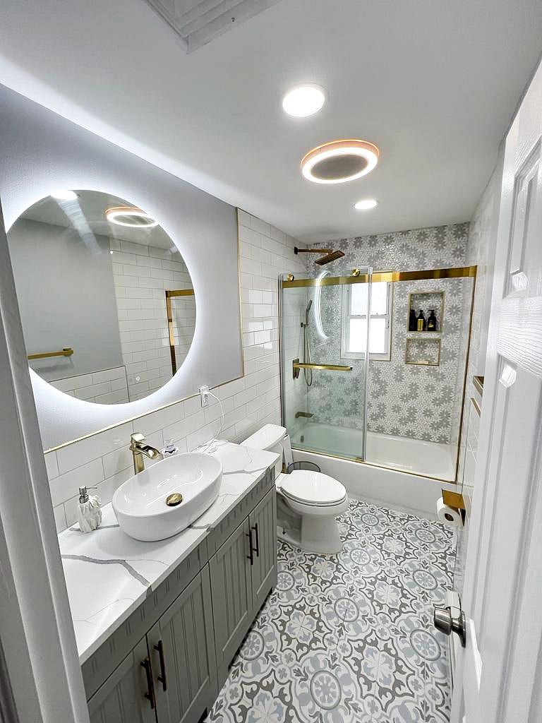 Full bathroom with lighted mirror and glass shower
