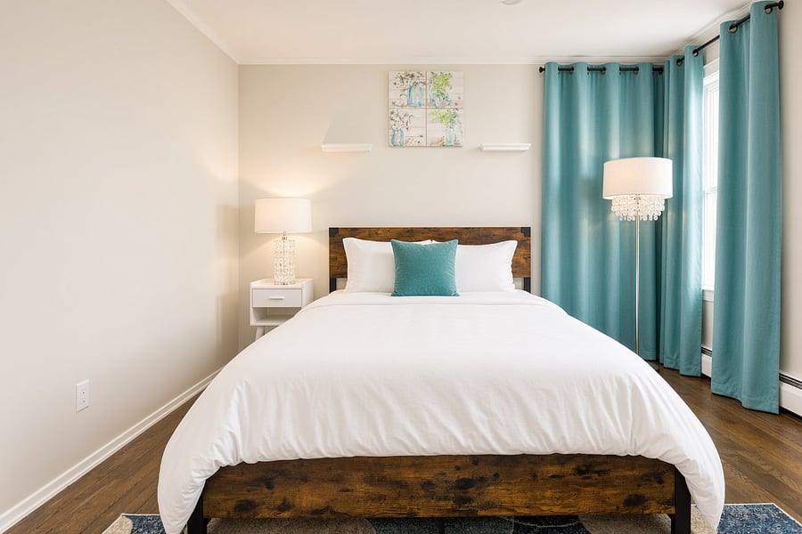 Primary bedroom with queen bed, nightstands and reading lamps