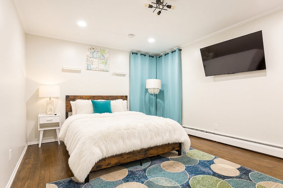 Primary bedroom with wall-mounted Smart TV