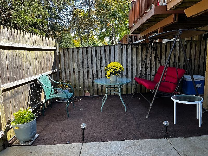Backyard sitting area with swing. 