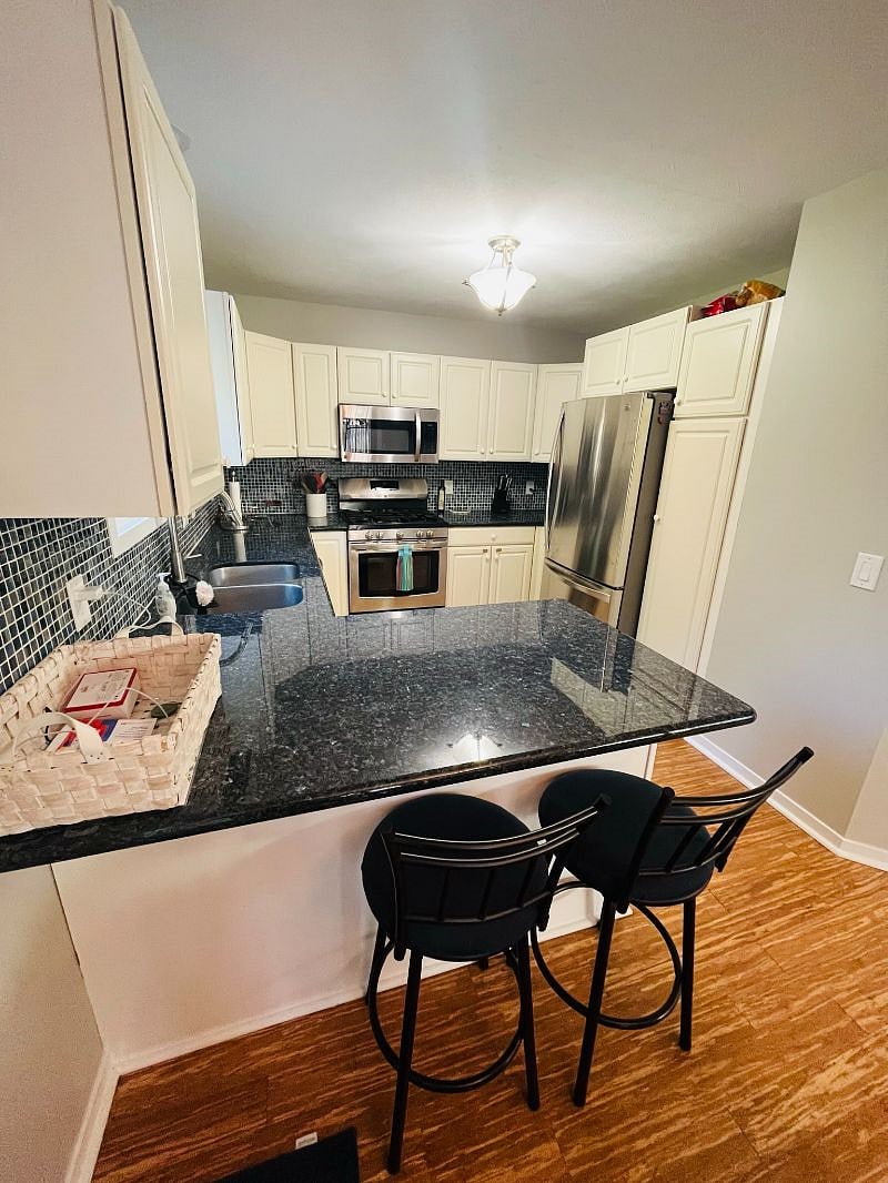 The kitchen has full-size appliances and a pantry for storage.
