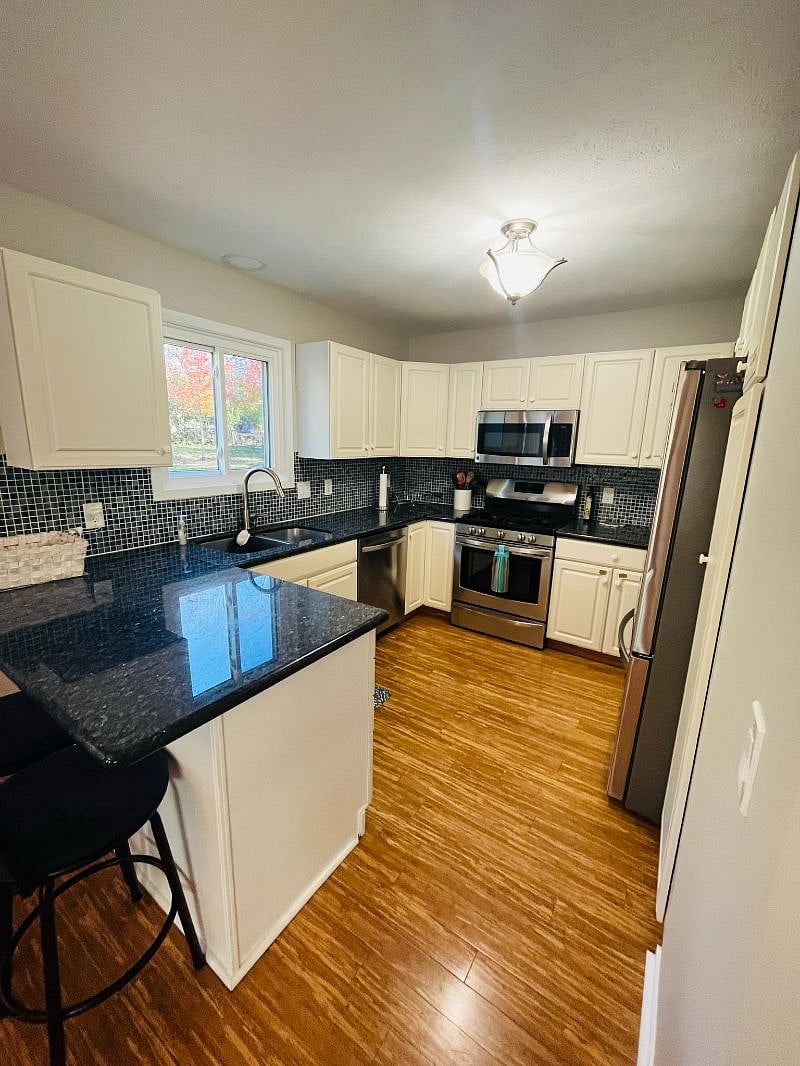 The kitchen is thoughtfully stocked with everything you need for cooking and baking, including a variety of spices and condiments.