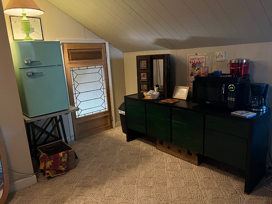 kitchenette with microwave, coffee maker and small frig.