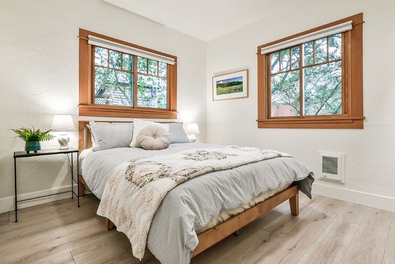 Bedroom #1 with Queen bed with new wooden bed frame, medium to firm comfy mattress with 2 down pillows and 2 non down pillows, down comforter and new cotton linens. Lots of natural light with black out shades for sleeping.