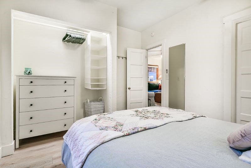 Good sized closet with plenty of hanging space, hangers, some hanging cubbies, a dresser and a laundry basket. clothing hooks behind the door and a mirror to the other side of the door.
