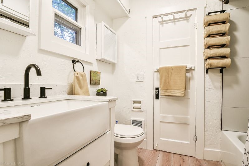 Bathroom with tub and shower combo, new linens and shower caddy to hold personal shower items. Bathroom has blow dryer and some essentials for getting your stay started.