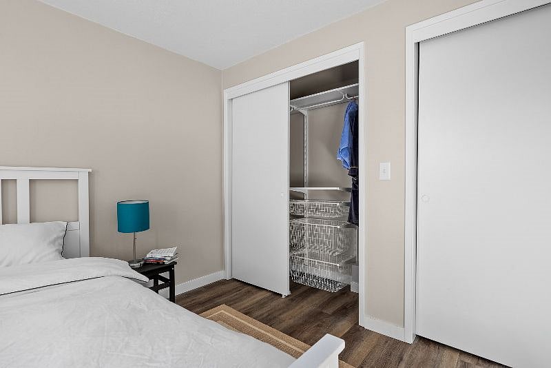 Bedroom 1 closet with integrated shelving and drawers.