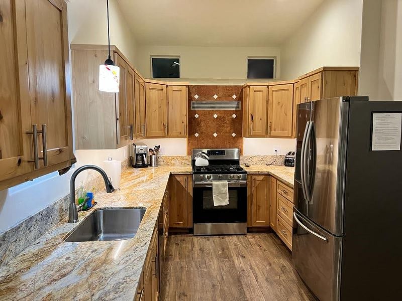 Large kitchen with new stainless steel Samsung appliances throughout, granite countertops, and is fully stocked with tons of cooking and serving necessities