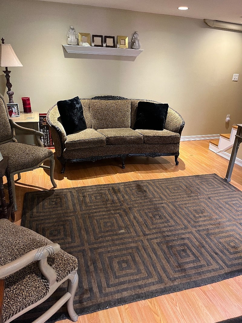 Couch in the office area in the basement .