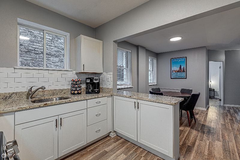 Kitchen with granite counters and peninsula bar. Fully stocked with coffee and cooking essentials.