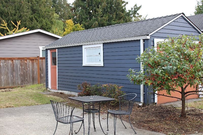Garage, lockable for bike or other storage. There are vegetable beds and a line of berry canes on the other side.