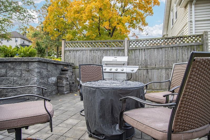 Backyard patio with seating, gas firepit and grill