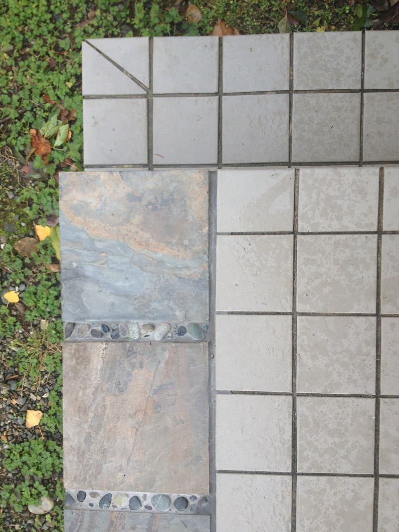 Slate tile details at your porch entry to the apartment. 2 slight steps lead to the door.