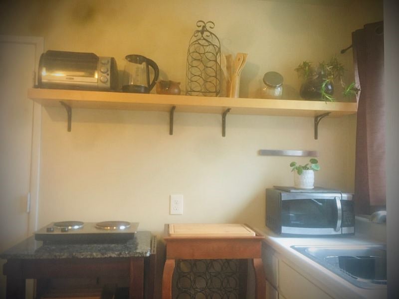 View of the kitchenette. The newer and spacious 3/4 size fridge is off to the left for easy access. Additional small appliances available to mix and match. 2 burner hotplate, not a full size stove. Toaster oven and microwave, etc.