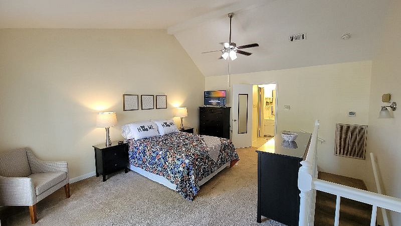 Upstairs bedroom w/ 40" smart TV and queen sized bed