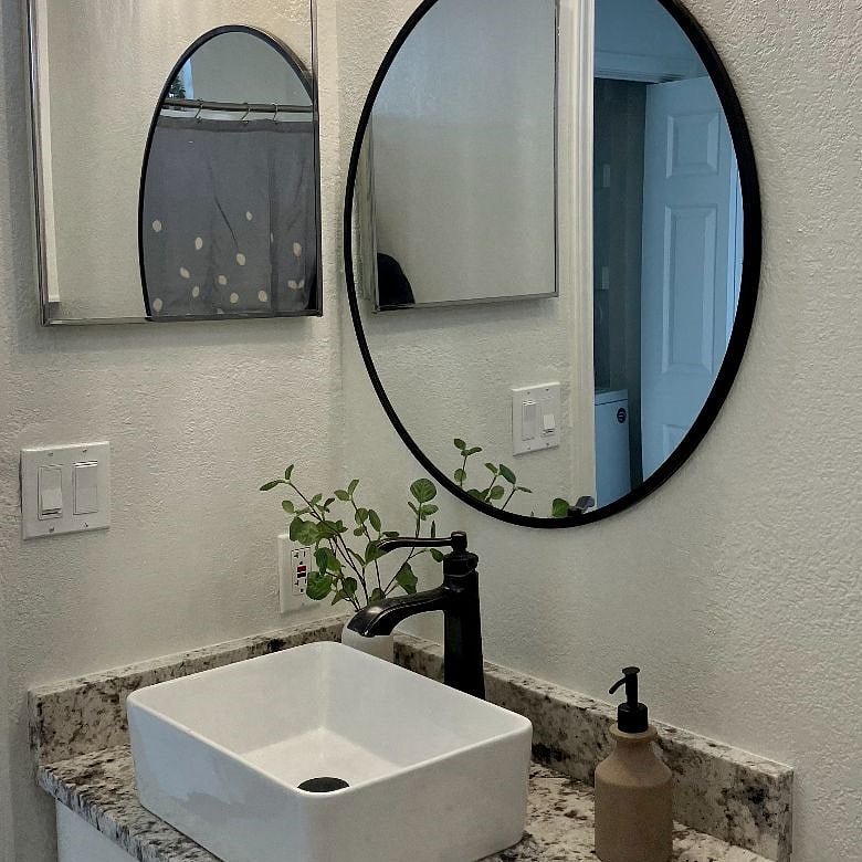 The upstairs bathroom, complete with granite countertops and modern sink.