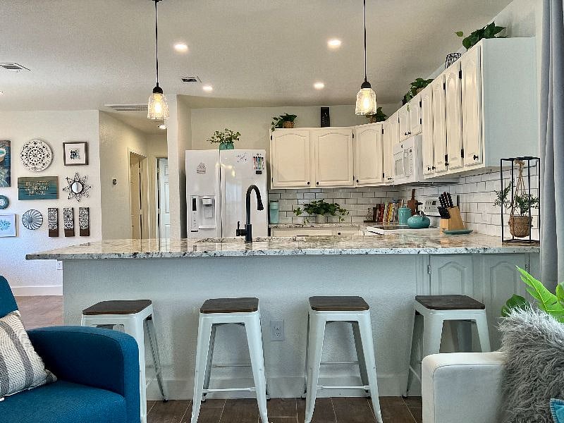 The kitchen adjoins the living room, making it easy to sit down with a glass of wine and chat with the cook!
