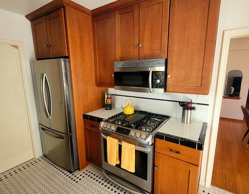 The kitchen features stainless appliances