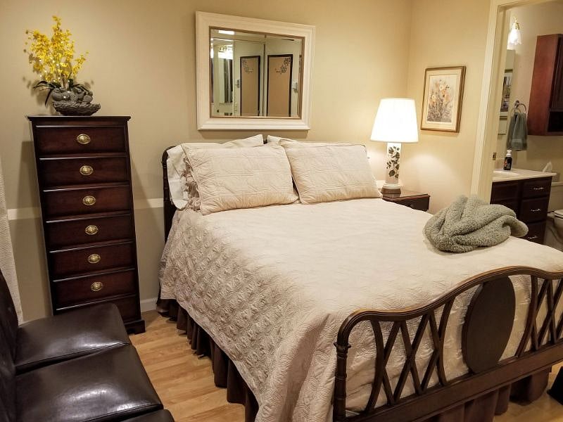 Double bed, chest, under bed storage, bathroom off to the side.