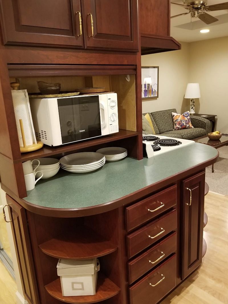 Furnished kitchen with microwave and range/oven.