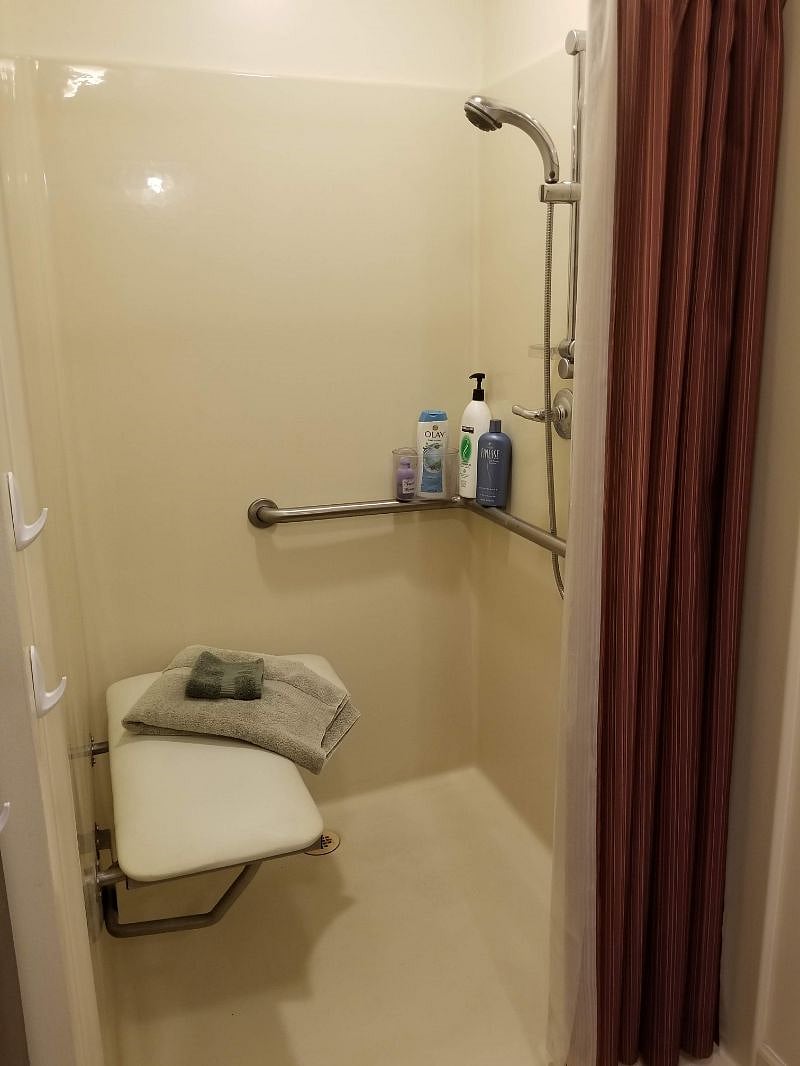 Large shower with fold-up bench.