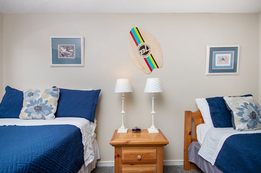 2nd bedroom with full size bed and twin size bed. Bedroom has a TV