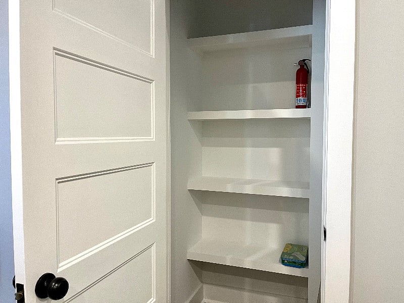 Large kitchen pantry with fire extinguisher.