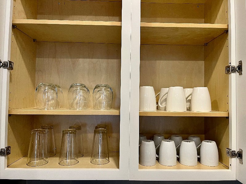 Well-stocked kitchen includes stemless wine glasses, coffee mugs and glassware.