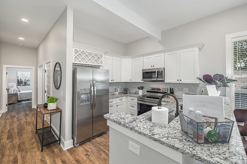 Well-equipped kitchen with SS appliances, including microwave, dishwasher, range with air-frying feature, fridge with door dispenser for ice and water, full -sized pantry and much more!