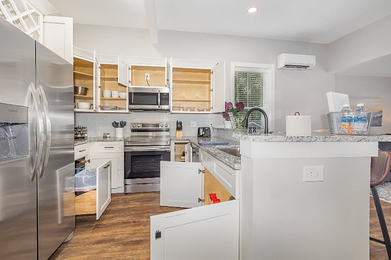 Stocked kitchen cabinets but still plenty of space for your own items. Plastic storage, mixing bowls, dishes and glassware for 8, coffee mugs, wine glasses, pots and pans, baking dishes and more.