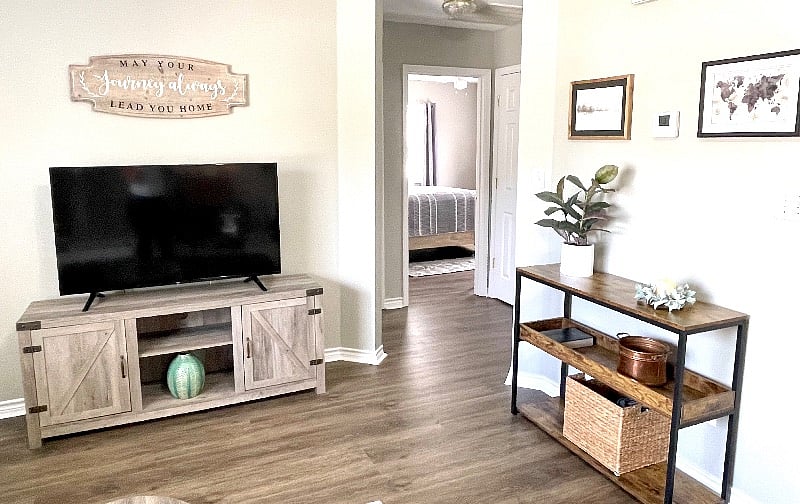A view from the living room into the hall leading to the bedrooms. Enjoy a 50 Smart TV with all the streaming apps loaded for your entertainment.