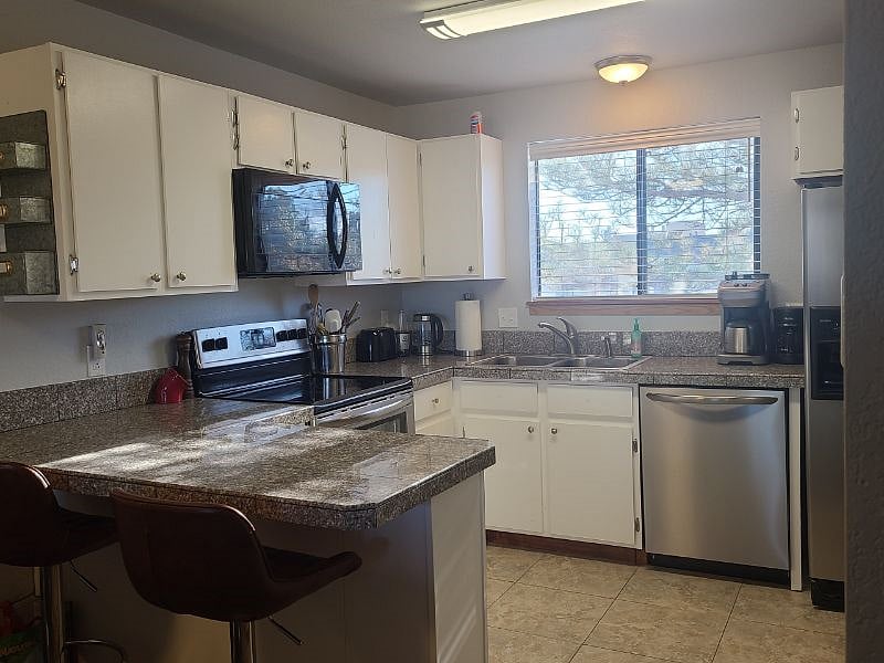 Fully stocked kitchen with dishwasher and full sized fridge. 