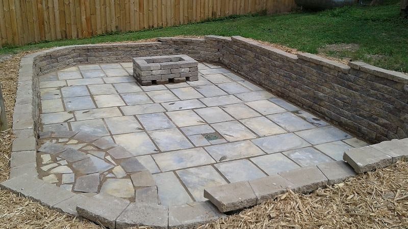 Back yard sunken patio with firepit. Camp chairs available for use. Cooler also available.