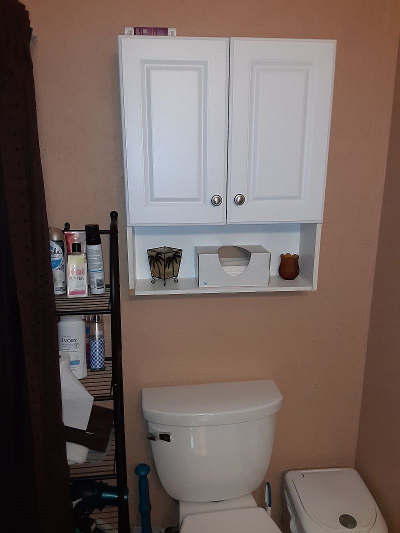 Private upper level main bathroom toilet & cabinet storage.