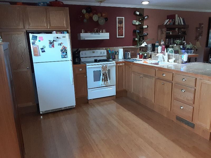 Main level open concept Kitchen / LR. No microwave, but can bring one (plenty of counter space). No dishwasher. New range. Large fridge w/ top freezer & ice maker. Condiments available.