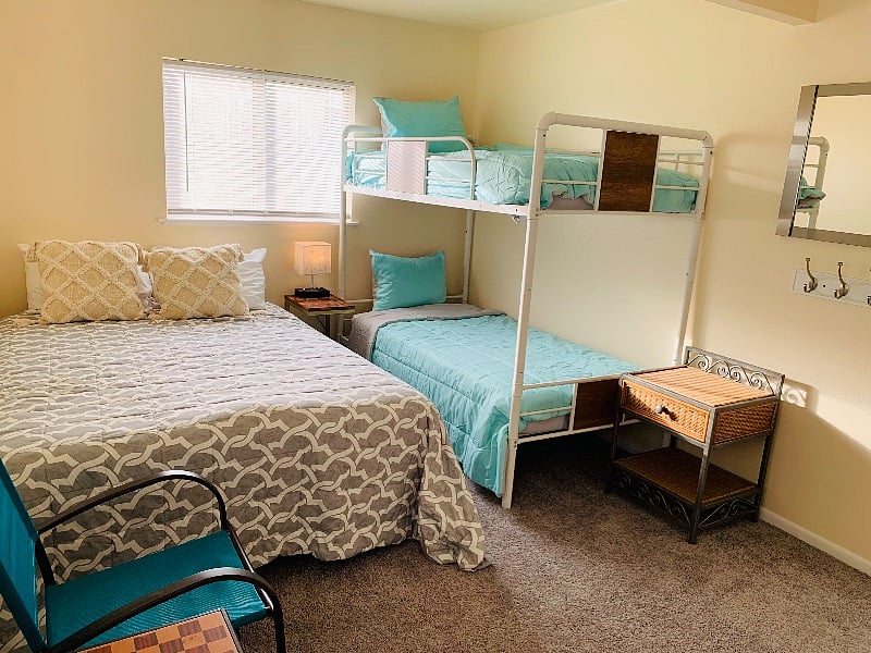 Bedroom 2. Queen bed and bunk beds. Closet
