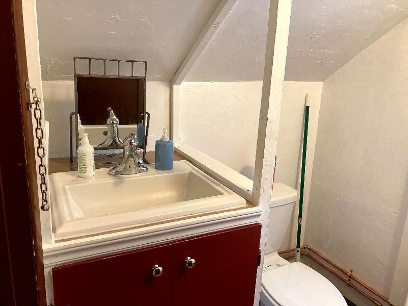 The toilet and sink are to the left of the shower and there is some storage room under the sink :-)