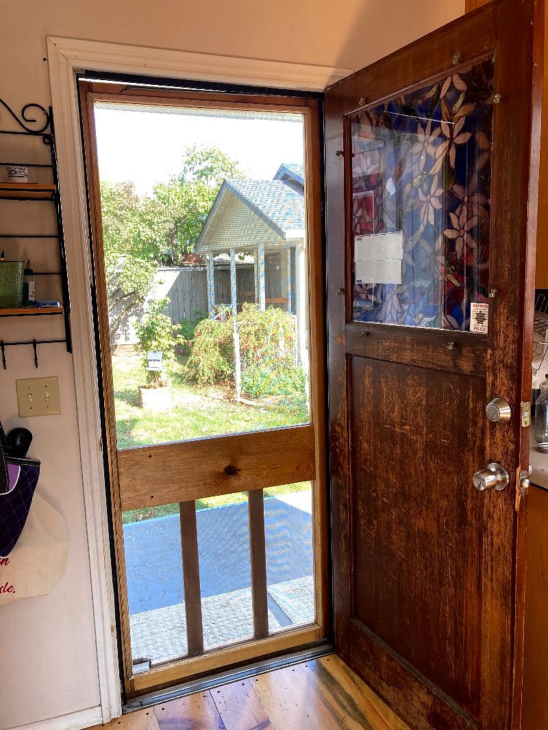 At the back of the kitchen there is a small porch which leads to the side yard - you can see the cottage where the on-site property manager lives.