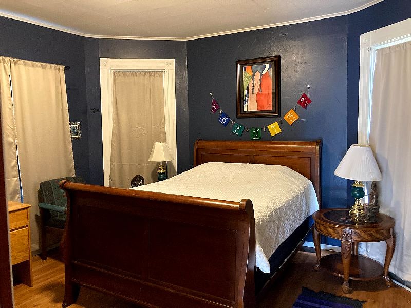 This downstairs bedroom with a queen bed is down a short hallway off the living room. This is the view with the curtains closed.