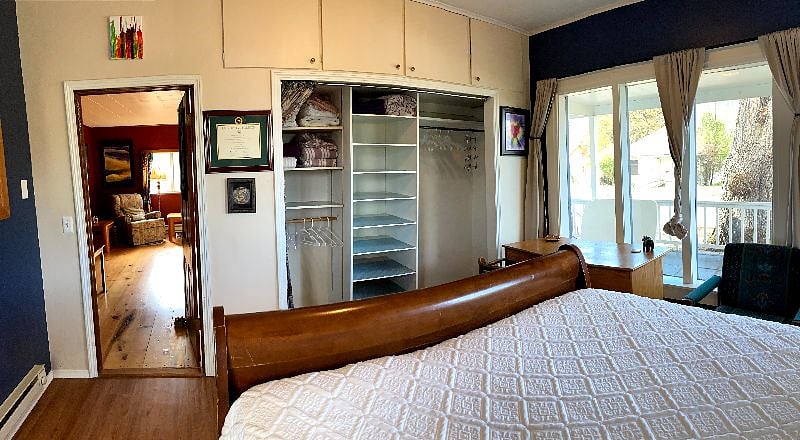This is the view of the downstairs bedroom from the head of the bed - this room sports a large built in closet with lots of room for folded and hanging clothes - above the closet is lots of storage space.