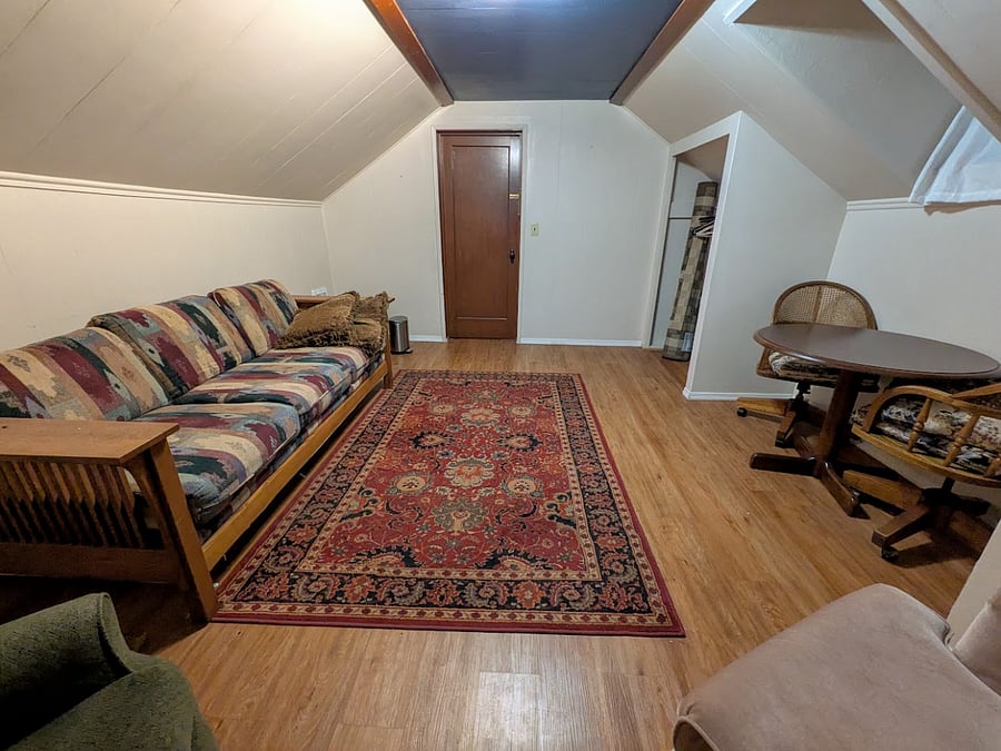 View from the window, facing the door. Through the door is the stair platform and a 3/4 bathroom - the other upstairs bedroom is on the other side of the bathroom.