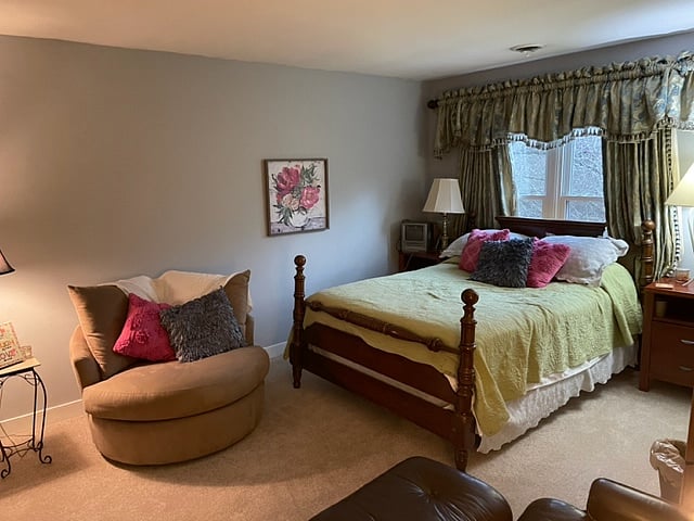 Gray bedroom furnished with queen bed.