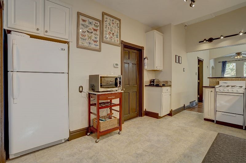 Kitchen showing door to basement where washer and dryer are located.