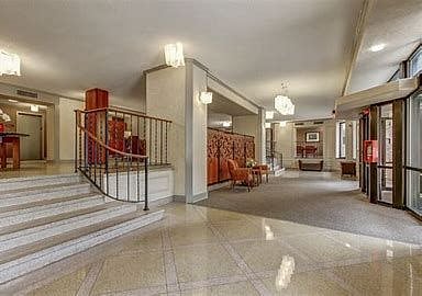 Entrance to the building. The mailboxes, sitting area, and mail opening center are decorated in an elegant setting. There is even a private conference area to chat with your visitors.