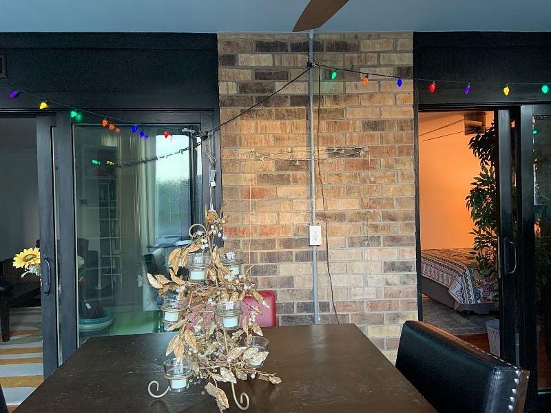 Sliding doors from enclosed balcony to bedroom or living room. The balcony has a lighted fan.