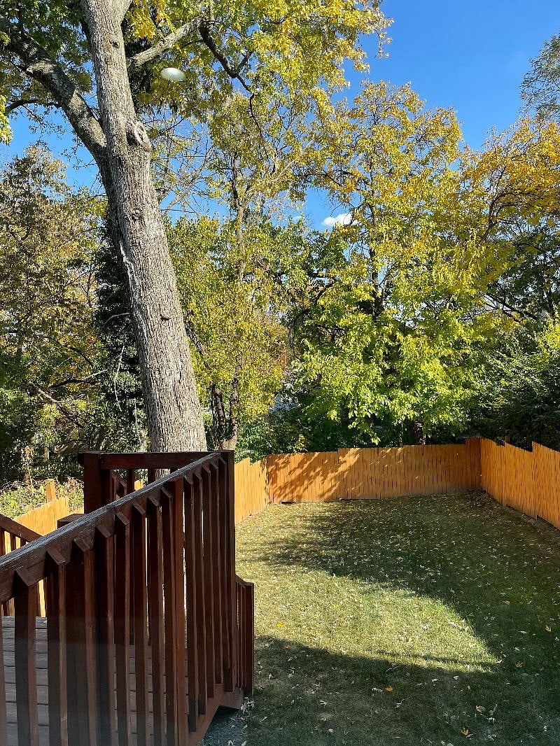 Fenced-in backyard with deck