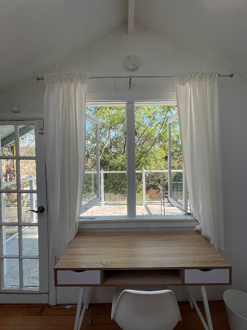 Bright, airy workspace with balcony in front.