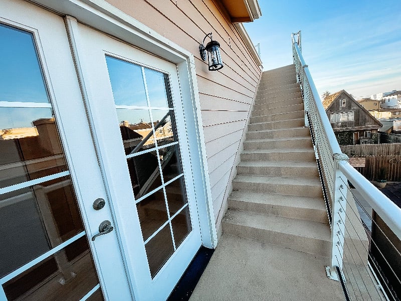 Outdoor stairs leading to the rooftop deck. 