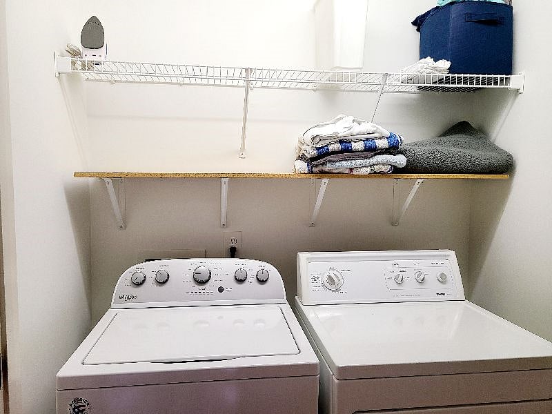 Washer and dryer across from office in hallway.