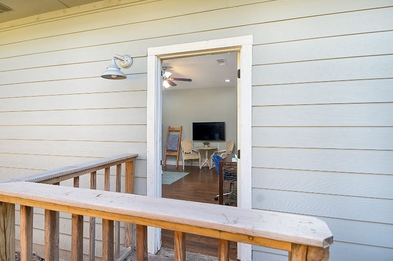 Bedroom 1 exterior door leading to a fully fenced in, private backyard.
